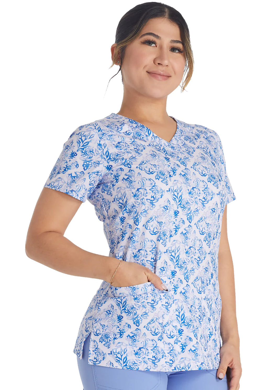 Woman wearing Dickies Medical V-Neck Print Top DK616 in blue floral pattern scrub top for healthcare professionals