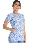 Woman wearing Dickies Medical V-Neck Print Top DK616 in blue floral pattern scrub top for healthcare professionals