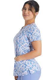 Woman wearing Dickies Medical V-Neck Print Top DK616 in blue floral pattern scrub top for healthcare professionals